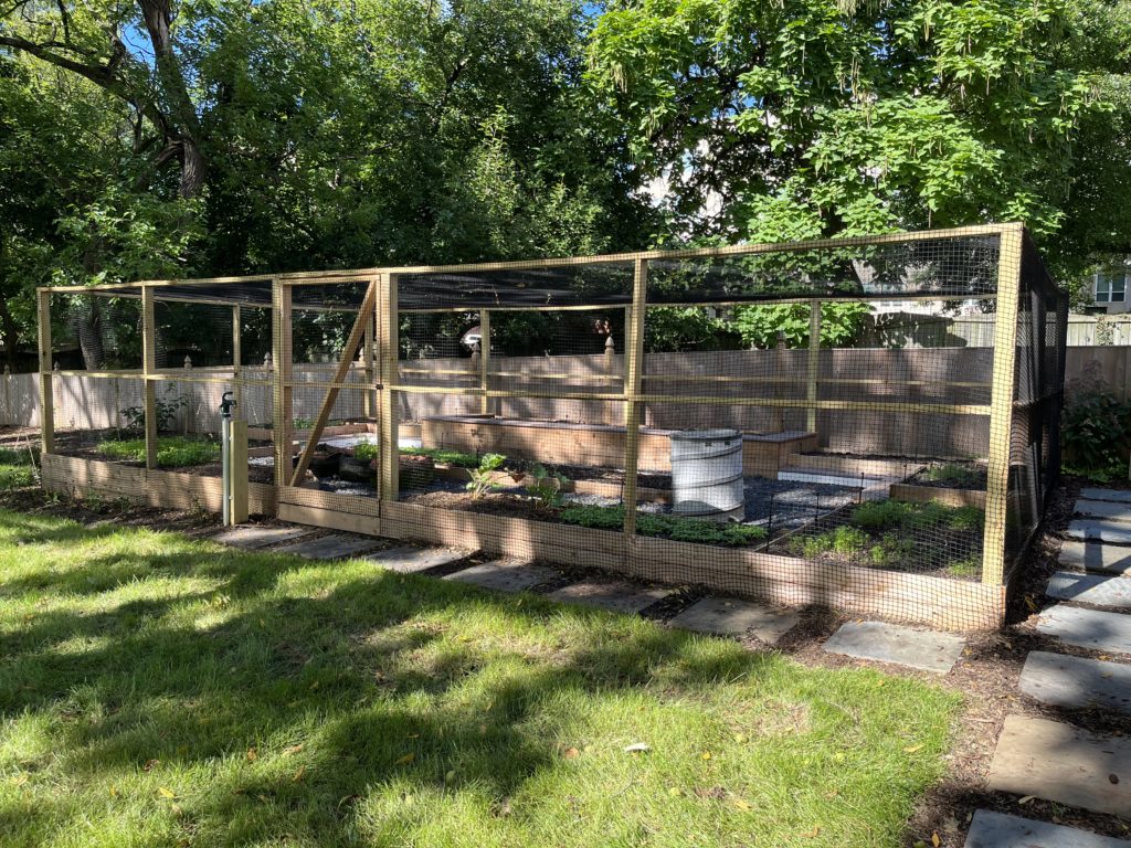 Outdoor backyard garden netting installation using 1" square mesh knotted nylon net.