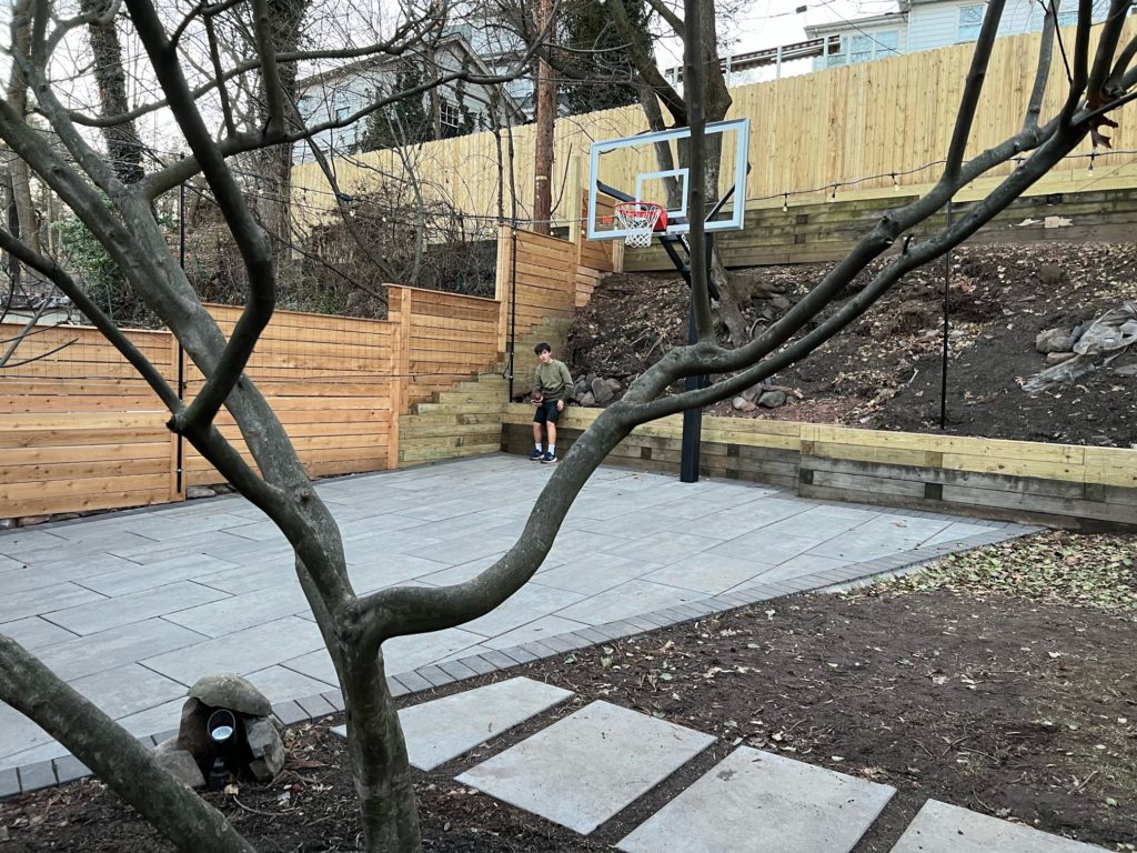 basketball containment netting at a driveway hoop.